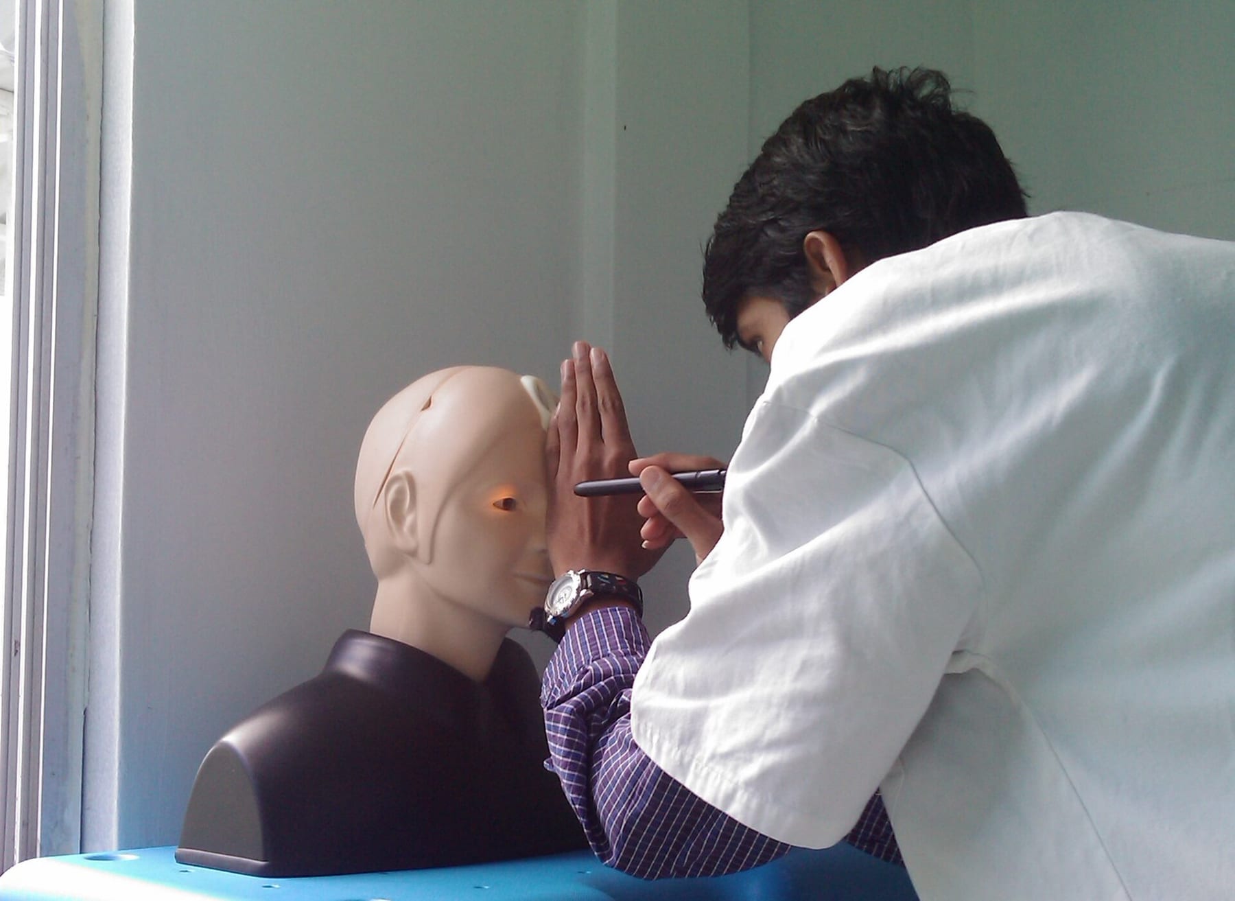 A medical student examining a patient