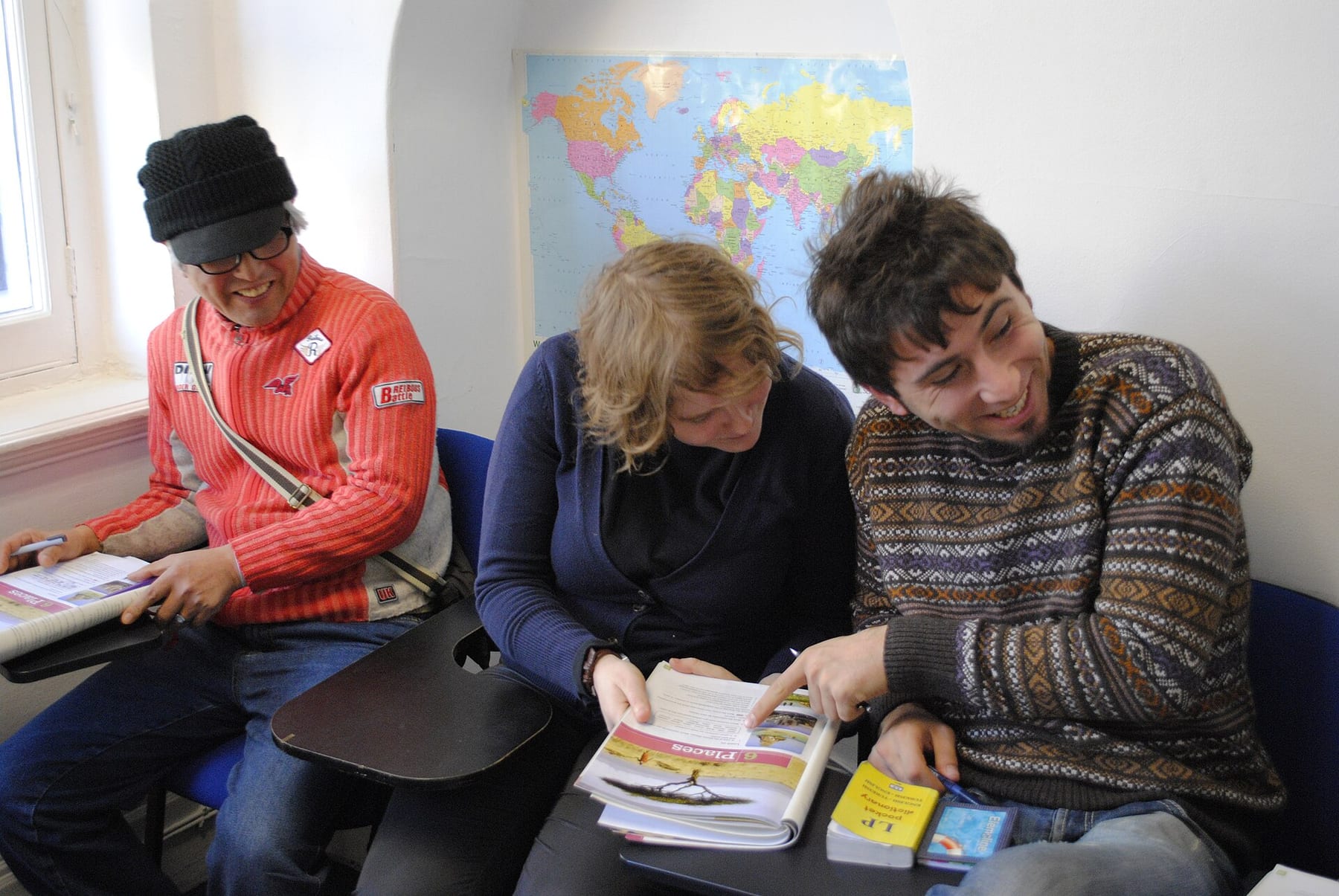 Students working through a language workbook together in class