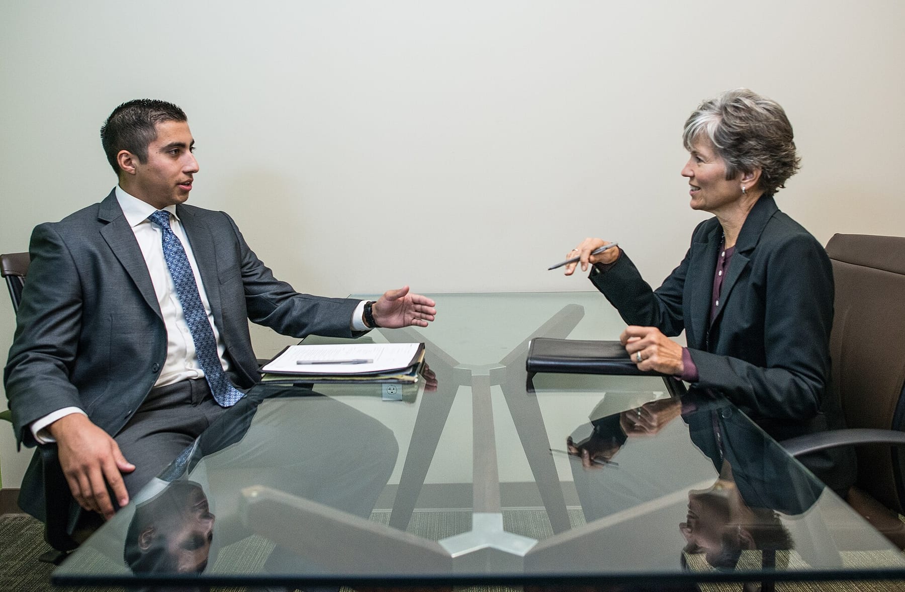 A student and an adviser talking across a desk